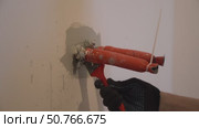 Apartment renovation. Isolation of electricity, preparation for connection. Painting walls with a brush around insulated wires. Стоковое видео, видеограф Darya Komarova / Фотобанк Лори
