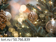 New Year's Eve card 2026. Christmas background. Holiday gold toys on the New Year's tree. Concept of preparing decorations and decor for the New Year. New Year's Eve card 2026. Стоковое фото, фотограф Photojuli / Фотобанк Лори