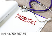 PROBIOTICS - word on a white sheet against the background of a stethoscope. Стоковое фото, фотограф Жанна Гапанович / Фотобанк Лори