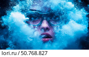 Enigmatic Woman in Goggles Amidst a Blue Cloud Burst. Стоковое AI-изображение, AI-художник Данила Большаков / Фотобанк Лори