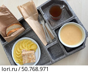 Hospital food on a hospital tray. Different dishes are arranged in the tray compartments. Стоковое фото, фотограф Vadzim Yakubovich / Фотобанк Лори