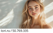 Woman with long golden hair poses against a light wall, showcasing natural beauty and serene expression in a soft and warm light Generative AI. Стоковое AI-изображение, AI-художник Елена Зубкова / Фотобанк Лори