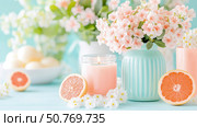 Pastel Spring Still Life: Scented Candle, Flowers, and Grapefruit. Стоковое AI-изображение, AI-художник Данила Большаков / Фотобанк Лори
