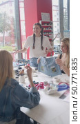 Several young fashion designers are collaborating to create a unique denim clothing line. Vertical. Стоковое видео, видеограф Strunov David / Фотобанк Лори