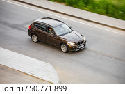 Car BMW X1 driving fast on city street with blurred background. Редакционное фото, фотограф Константин Григорьев / Фотобанк Лори