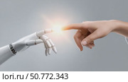 Robotic and human hands touching, creating a spark of light. Стоковое AI-видео, аниматор Юрий Поздников / Фотобанк Лори