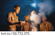 Indigenous man starting fire with sticks at night ceremony. Стоковое AI-видео, аниматор Юрий Поздников / Фотобанк Лори
