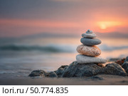 A stack of balanced stones on the beach. Стоковое AI-изображение, AI-художник Boris Vasilenko / Фотобанк Лори
