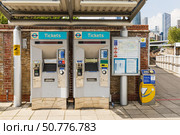 Docklands Light Railway ticket machines and Oyster reader on DLR platform. London, UK, 19 May 2024. Редакционное фото, фотограф Zydrius Tartenis / Фотобанк Лори
