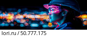 Neon-lit Engineer: Woman in Hard Hat and Goggles Against City Lights. Стоковое AI-изображение, AI-художник Данила Большаков / Фотобанк Лори
