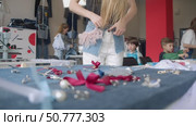 A girl tries on a skirt at a craft denim clothing store, which has a unique design and decoration. Стоковое видео, видеограф Strunov David / Фотобанк Лори
