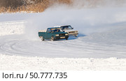Two cars are driving on a snowy road, one of which is a truck. Стоковое фото, фотограф Скрипачев Антон / Фотобанк Лори