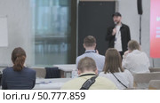 Participants Listening to a Speaker During a Business Presentation in a Modern Setting. Стоковое видео, видеограф Антон Гвоздиков / Фотобанк Лори