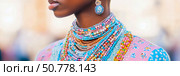 Close-up of a Woman Adorned with Multicolored Beaded Necklaces and Earrings. Стоковое AI-изображение, AI-художник Данила Большаков / Фотобанк Лори