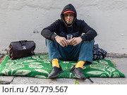 Sad homeless man begs for money at the street. Стоковое фото, фотограф Михаил Яковлев / Фотобанк Лори