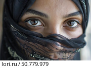 Muslim woman wearing niqab, revealing expressive brown eyes. Стоковое AI-изображение, AI-художник Иван Рябоконь / Фотобанк Лори