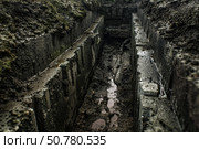 Drainage ditch with concrete walls during rain. Стоковое AI-изображение, AI-художник Иван Рябоконь / Фотобанк Лори