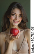 A Young Woman Gazes Softly While Holding a Shiny Red Apple, Exuding Calmness and Enchantment With Her Serene Expression. Стоковое AI-видео, аниматор Sergey Grishin / Фотобанк Лори