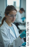 A Dedicated Scientist Carefully Examines a Sample in a Clean, Bright Laboratory Setting. Стоковое AI-видео, аниматор Sergey Grishin / Фотобанк Лори