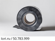 Roll of black polyethylene film laying on white background. Стоковое AI-изображение, AI-художник Иван Рябоконь / Фотобанк Лори