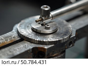 Measuring equipment showing fine adjustment knob and scale being used for precision engineering. Стоковое AI-изображение, AI-художник Иван Рябоконь / Фотобанк Лори