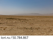 Arid Kunduz Province, Afghanistan, features sparse vegetation and distant mountains (2024 год). Стоковое фото, фотограф Михаил Пряхин / Фотобанк Лори