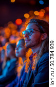 Attentive Man in Audience at Illuminated Event, Captivated by Presentation. Стоковое AI-изображение, AI-художник Данила Большаков / Фотобанк Лори