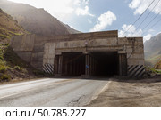 M34 highway tunnel entrance in Tajikistan surrounded by mountainous terrain. Стоковое фото, фотограф Михаил Пряхин / Фотобанк Лори