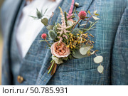 Groom wearing boutonniere on blue suit jacket, wedding celebration. Стоковое AI-изображение, AI-художник Иван Рябоконь / Фотобанк Лори