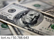 One hundred dollar bills showing benjamin franklin portrait laying on a pile of money. Стоковое AI-изображение, AI-художник Иван Рябоконь / Фотобанк Лори