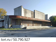 Abandoned cinema building showing decaying facade and broken windows. Стоковое AI-изображение, AI-художник Иван Рябоконь / Фотобанк Лори