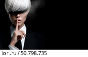 Model poses with a mysterious aura while dressed in a black suit indoors. Стоковое AI-изображение, AI-художник Katsiaryna Repich / Фотобанк Лори