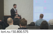 Participants Listening to a Speaker During a Business Presentation in a Modern Setting. Стоковое видео, видеограф Антон Гвоздиков / Фотобанк Лори
