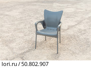 Plastic black chair on the gray background. Стоковое фото, фотограф Татьяна Куклина / Фотобанк Лори
