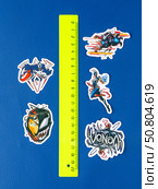 Novosibirsk, Russia - March 1, 2025: Cartoon-style vinyl stickers featuring Venom in various comic book situations on a bright blue background. Редакционное фото, фотограф Виталий Сова / Фотобанк Лори