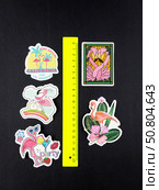 Novosibirsk, Russia - March 1, 2025: Cartoon style vinyl stickers featuring bright pink flamingos in different situations on a bright black background. Редакционное фото, фотограф Виталий Сова / Фотобанк Лори
