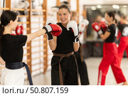 Women fight with hands, using all strength, courage during boxing lesson. Стоковое фото, фотограф Яков Филимонов / Фотобанк Лори