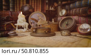 Vintage style travel and adventure. Vintage old compass and other vintage items on the table. Стоковое видео, видеограф Андрей Армягов / Фотобанк Лори