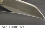 Scissors cutting fabric along a chalk line in a garment factory during the cutting process. Стоковое видео, видеограф Дмитрий Нечаев / Фотобанк Лори