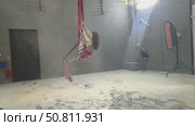 Woman practices aerial silk in a studio setting during a beauty routine. Стоковое видео, видеограф Гурьянов Андрей / Фотобанк Лори