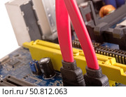 Материнская плата компьютера и соединительные кабели SATA. Computer motherboard, electronic components on circuits board. Стоковое фото, фотограф Татьяна Д / Фотобанк Лори