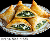 Spinach and feta stuffed spanakopita. Стоковое AI-изображение, AI-художник Татьяна  Бральнина / Фотобанк Лори