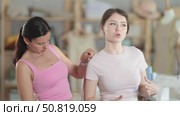 Woman tailor takes measurements from girl client. Стоковое видео, видеограф Яков Филимонов / Фотобанк Лори