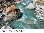 Ala-Archa Park, Fast flowing glacial river winding through rugged rocks and boulders in a high altitude mountain landscape. Hiking, trekking, mountaineering and wilderness exploration activities. Стоковое фото, фотограф Андрей Ка / Фотобанк Лори