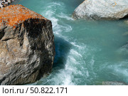 Ala-Archa Park, Fast flowing glacial stream with clear blue water, rugged boulders, and wild terrain, representing pristine nature, outdoor adventure, and challenging mountain travel environments. Стоковое фото, фотограф Андрей Ка / Фотобанк Лори
