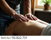 Мужчина-врач делает массаж. A male doctor does a massage. Стоковое AI-изображение, AI-художник Смирнова Светлана / Фотобанк Лори