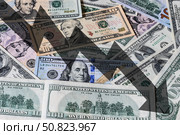 Arrow down on the background of dollar bills. The concept of inflation, depreciation of the dollar or the US economy. Стоковое фото, фотограф Емельянов Евгений Викторович / Фотобанк Лори