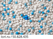 White cat litter round particles surface with small blue colored particles, top view. Granules of pet white-gray litter background. Dog litter texture backdrop with small dots. Flat lay, copy space. Стоковое AI-изображение, AI-художник Марина Демидюк / Фотобанк Лори