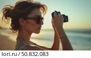 Close up on woman rewind film to next frame on old vintage camera. Millennial hipster photography hobby. Cinematic film photocamera in soft sunset light at beach. Стоковое AI-видео, аниматор Sergey Grishin / Фотобанк Лори