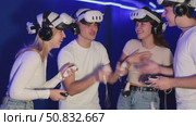 Group of friends chat animatedly after playing virtual reality. Стоковое видео, видеограф Яков Филимонов / Фотобанк Лори